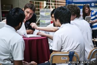 Charles Martin, Contemporary World teacher at Westmount High School, talks with students at the ePearl exhibition in the LB Atrium during Human Rights Day.
